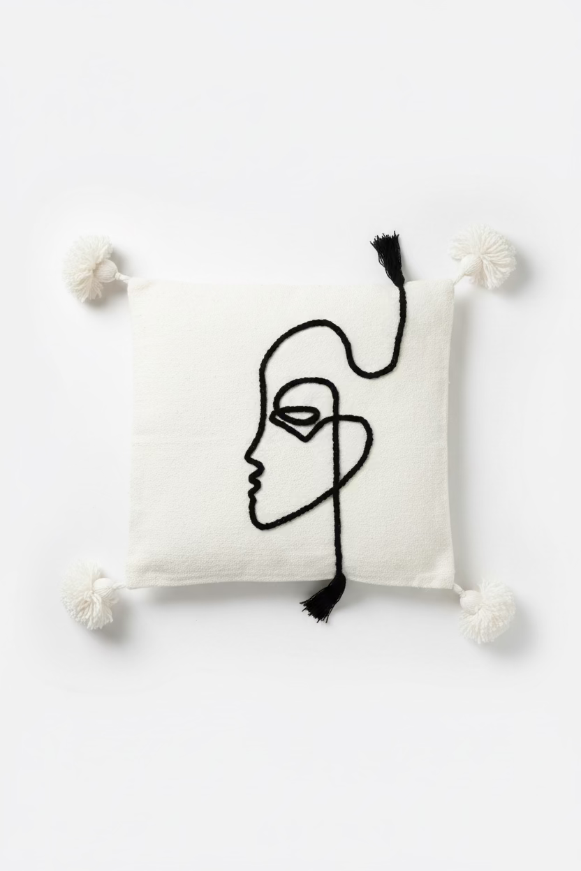 Housse de coussin visage de profil one line brodé ivoire et noir — pompons artisanat marocain fait main